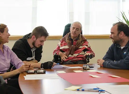 reunião entre pessoas, entre as quais homem com deficiência ao nível da mobilidade
