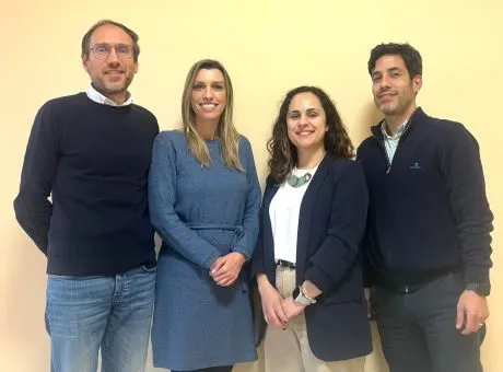 fotografia de quatro pessoas em pé, lado a lado, a olhar para a camera