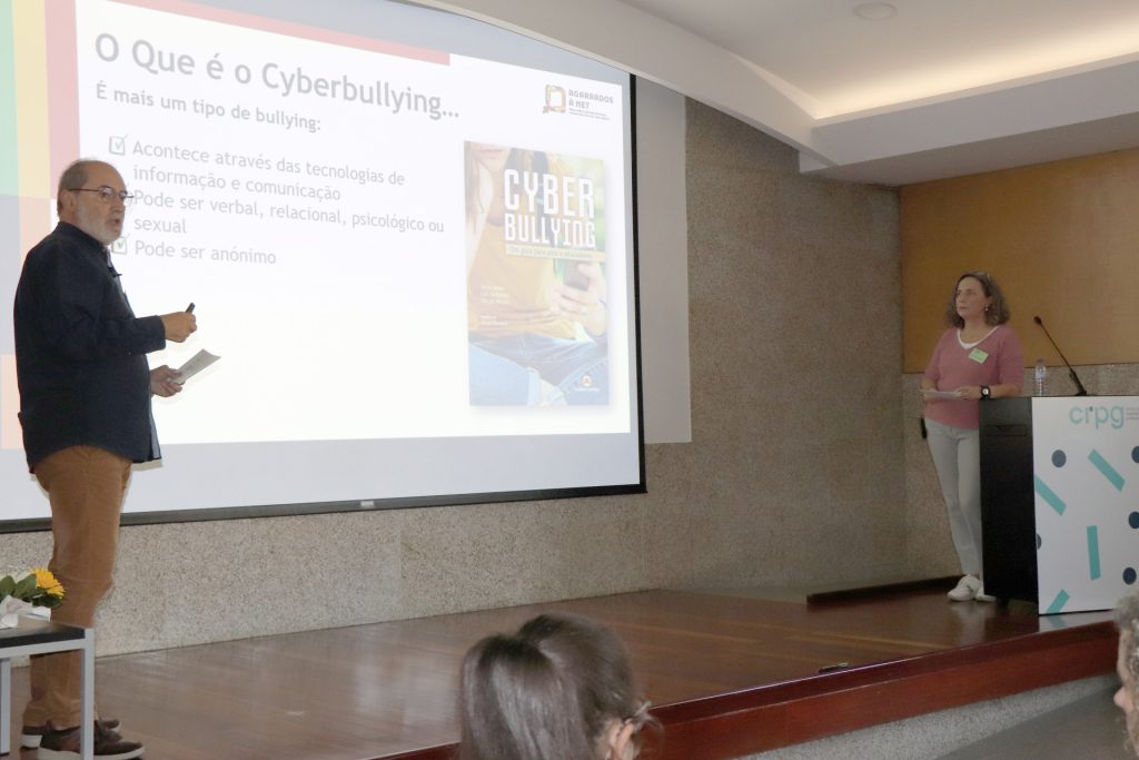 fotografia de orador no palco com projeção na tela