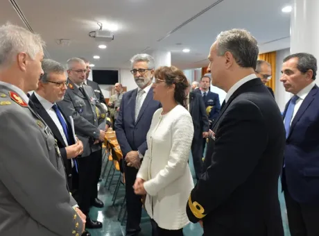 Fotografia da Ministra da Defesa Nacional a falar com Jerónimo Sousa no dia da apresentação do SAPADM rodeados de pessoas a observar.