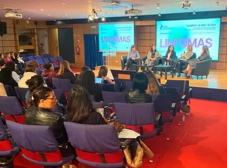 fotografia de pessoas sentadas a olhar para o palco enquanto decorre uma mesa redonda